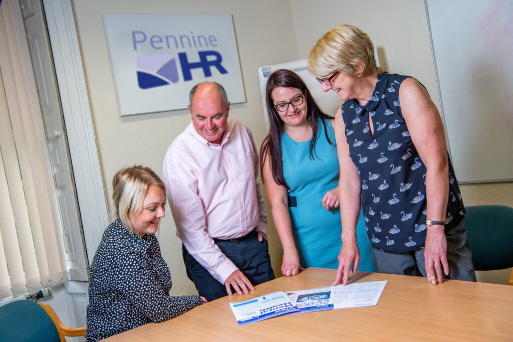 Pennine HR consultants reviewing a document